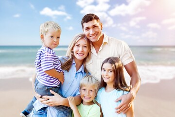 Happy family with children having fun on the beach