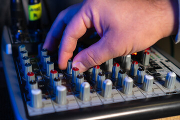 Close-up of sound mixer console in recording studio. Men's Hand Adjustment Manual Adjustment...
