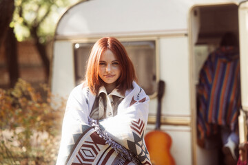 A captivating girl showcases her hippie-inspired look against the park landscape, with a trailer...