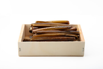 A wooden box filled with razor clams isolated on a white background, showcasing the seafood delicacy