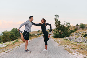 A Romantic Couple Stretching Down After a Run
