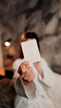 A young woman tells fortunes with cards. A woman wants to know her destiny. The concept of magic and fortune telling. Vertical video