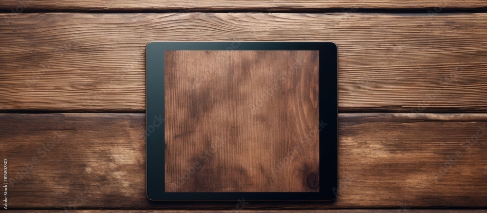 Poster tablet device with digital screen displayed on a rustic wooden surface providing ample space for cre