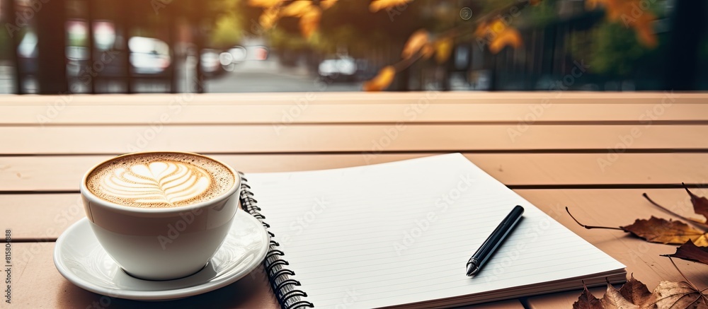 Aufkleber a copy space image of a coffee cup next to a notepad on a table