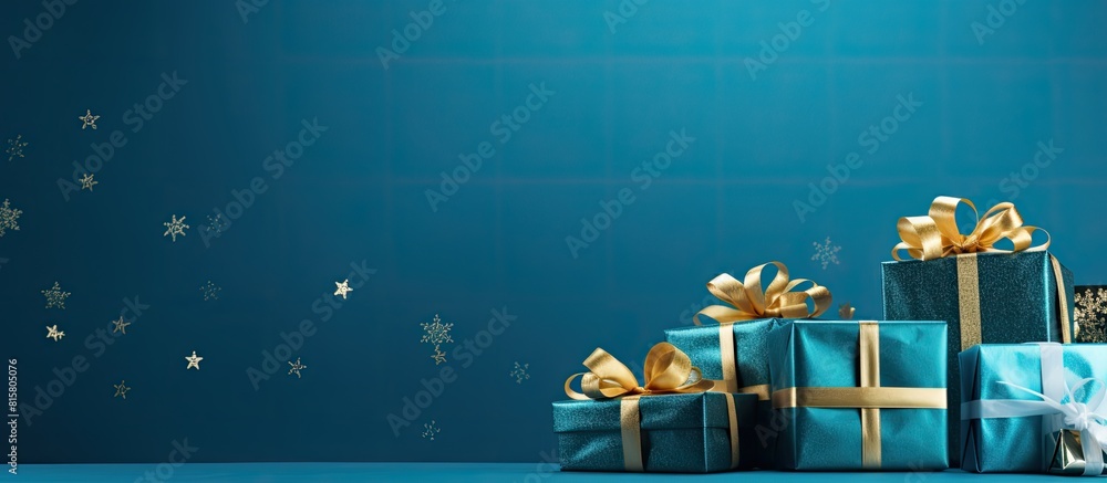 Poster A photo of Christmas presents placed on a blue backdrop with an empty area emphasizing negative space image. Copyspace image