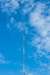 Obraz premium Tall, built structure telecommunications antenna. Low angle view, blue sky, no people