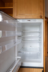 Fototapeta premium Open door home refrigerator with empty shelves, no people