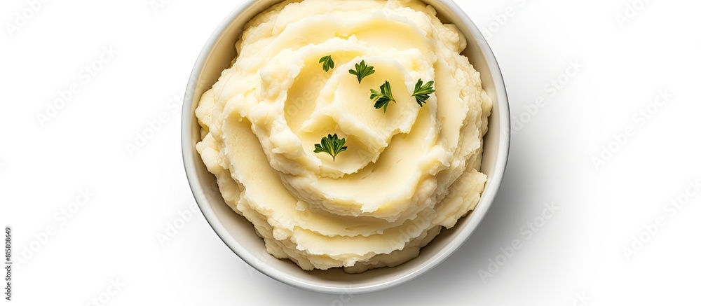 Poster top view of a bowl filled with delicious mashed potatoes providing a white background with enough em