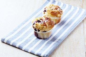 Muffins on bright wooden background. Close up. Copy space.	