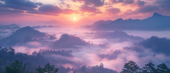 The first light of dawn breaks over the misty mountains.