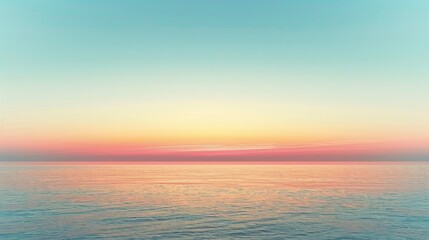 Obraz premium Tranquil ocean at sunset with a clear blue sky.