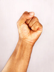 Clenched fist of a dark skin hand male
