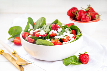 Stack of chocolate nutella filled pancakes. Sweet breakfast pancakes with chocolate sauce inside it, and fresh stawberries, on white kitchen table