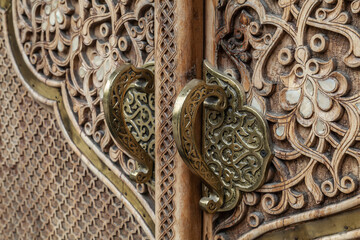 Door handle and door. Wooden national patterns in Uzbekistan