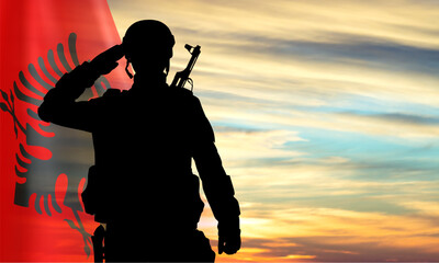 Silhouette of a saluting soldier with Albania flag against the sunset. EPS10 vector