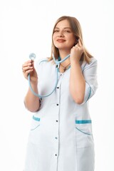 A girl pediatrician in a white coat with a stethoscope. Photo on a white background. Grain effect used