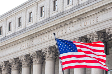 USA national flag waving in the wind in front of United States Court House in New York