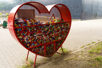 Heart-Shaped Container Collecting Plastic Plugs for Recycling in Urban Park