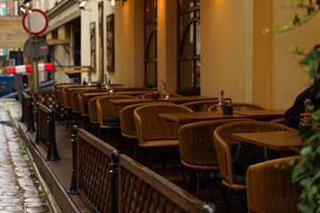 Empty Street Cafe With Wicker Chairs On A Rainy Evening In The City