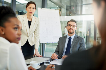 Business people, meeting and discussion with team in boardroom for corporate finance or collaboration at office. Group of employees discussing company revenue, profit or project budget at workplace