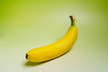 Close-up shot of yellow banana against green background