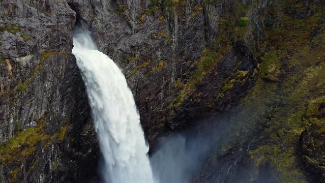 Breathtaking aerial view of the huge waterfall and the valley that surrounds it. Bird's eye view. Norway, Manafossen.