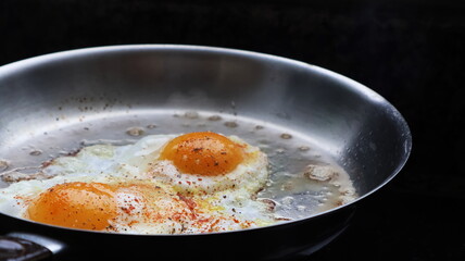 Eggs in a frying pan closeup in color
