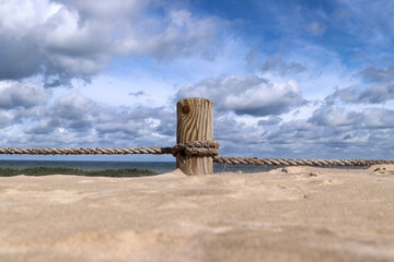 Pillar covered in sand on the hiking trail through the Lacka gora dune near Leba village  in the...