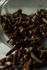 Photograph of cloves in a glass jar with daylight. Concept of natural ingredients