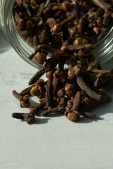 Photograph of cloves in a glass jar with daylight. Concept of natural ingredients