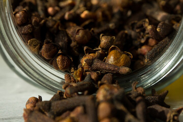 Photograph of cloves in a glass jar with daylight. Concept of natural ingredients