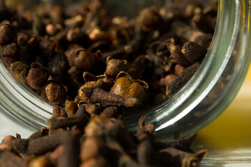 Photograph of cloves in a glass jar with daylight. Concept of natural ingredients