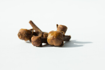 Macro photograph of cloves on white background. Concept of natural ingredients