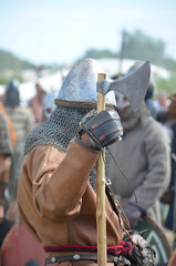 A man dressed as a medieval warrior with an axe, according to medieval patterns during historical reconstructions, on the island of Wolin in Poland, at a meeting of Vikings and Slavs