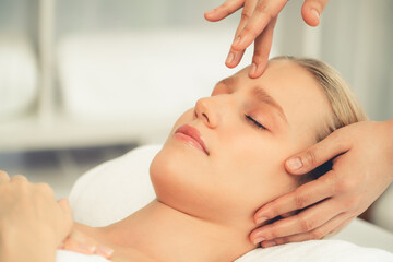 Caucasian woman enjoying relaxing anti-stress head massage and pampering facial beauty skin...