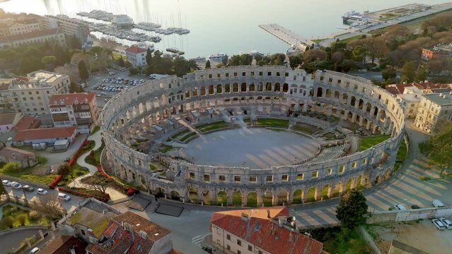 Aerial view of Colosseum Arena in Pula. Old Roman amphitheatre and old town in Pula, Istria, Croatia at sunrise