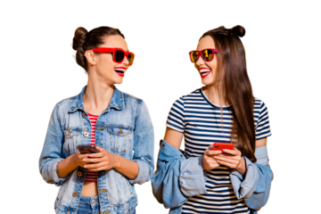 Two brunette hair lady in glasses spectacles street style stylish trendy casual denim jeans look each other stand isolated on yellow bright background hold cellular gadget in hands