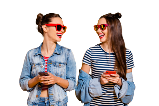 Two brunette hair lady in glasses spectacles street style stylish trendy casual denim jeans look each other stand isolated on yellow bright background hold cellular gadget in hands - Powered by Adobe