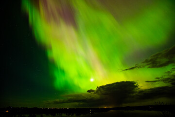 The Aurora Borealis or northern lights creates a incredible display of beautiful multi colored...