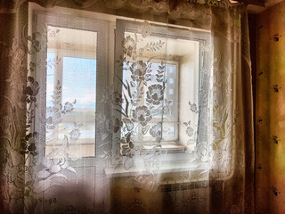Morning Light Filtering Through Lace Curtains in a Cozy Room. Chiffon curtain on the window in the...