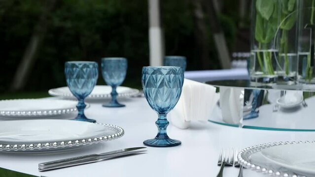 Festive buffet. A waiter in a stylish suit places dishes on the festive table and waits for the guests of the holiday. The concept of a holiday, official events and buffet table.