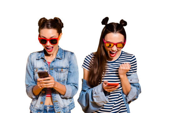 Sale discount concept. Two brunette hair lady in street style stylish casual denim jeans trendy glasses spectacles isolated on yellow vivid background hold gadget read send receive sms message - Powered by Adobe