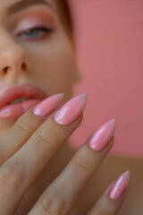 A woman with pink nails and a pink background.