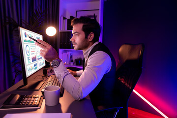 Smart businessman pointing with pen on desk to focusing research target market in service product...