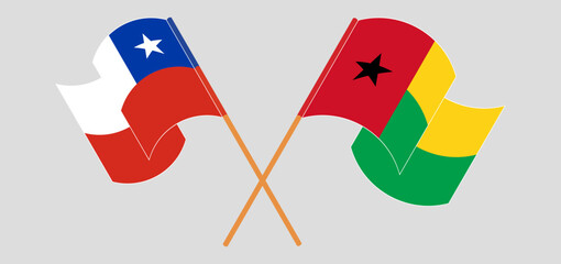 Crossed and waving flags of Chile and Guinea-Bissau