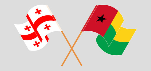 Crossed and waving flags of Georgia and Guinea-Bissau