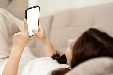 Young Woman Using Smartphone In Bed, Engaged In Technology And Connectivity, Capturing The Essence...