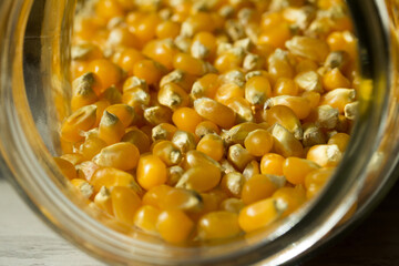 Macro photo of raw corn inside a glass jar.