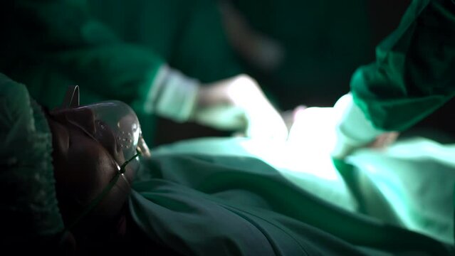 Team of surgical doctors performing a surgical operation in the operation room.