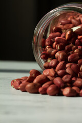 Macro shot of peanuts inside a glass jar.